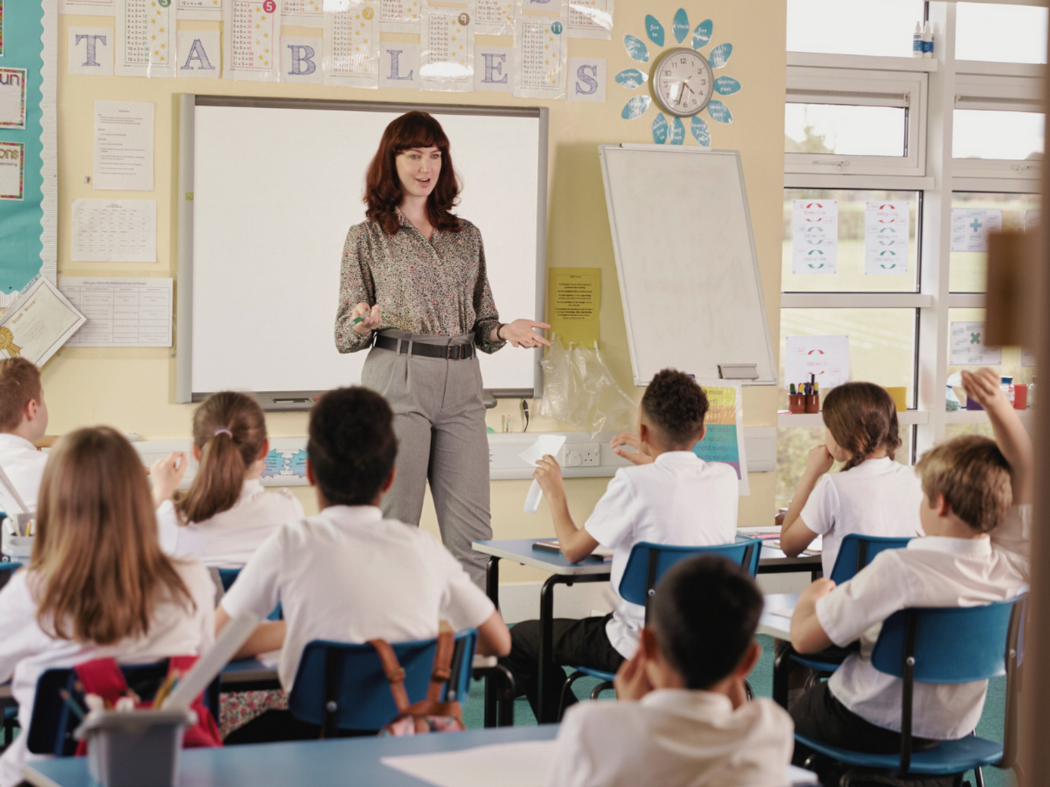 A teacher in a class of primary pupils learning grammar