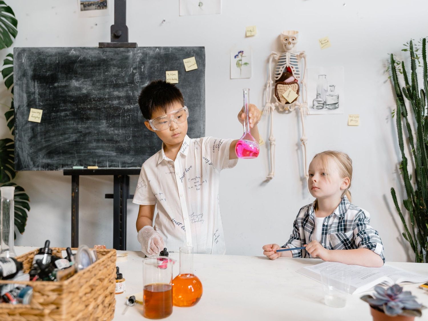 Two children doing science experiments in a science classroom