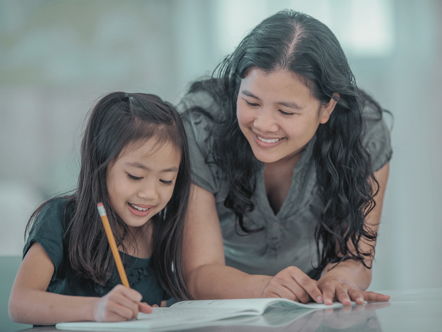 A parent helping their child put literacy knowledge into action